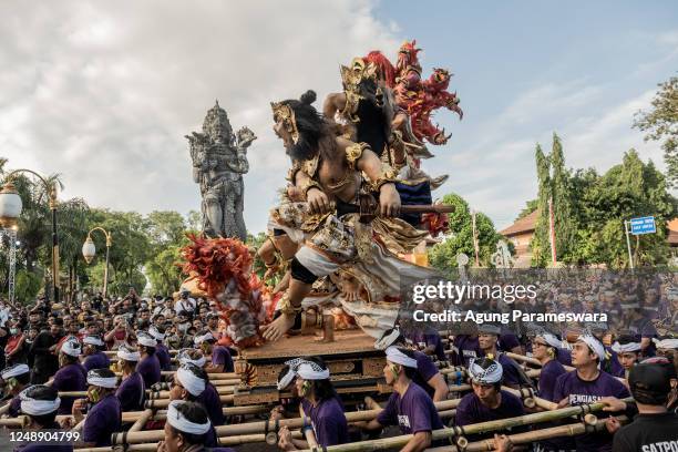 Balinese youths carry ogoh-ogoh, the giant menacing-looking dolls during Kasanga Festival on the eve of Nyepi, the Balinese Hindu Day of Silence that...