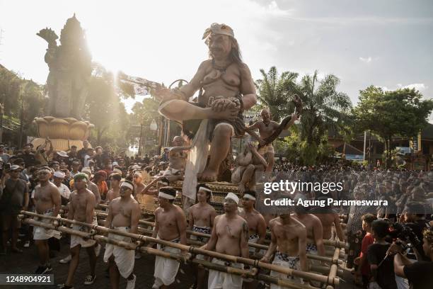 Balinese youths carry ogoh-ogoh, the giant menacing-looking dolls during Kasanga Festival on the eve of Nyepi, the Balinese Hindu Day of Silence that...