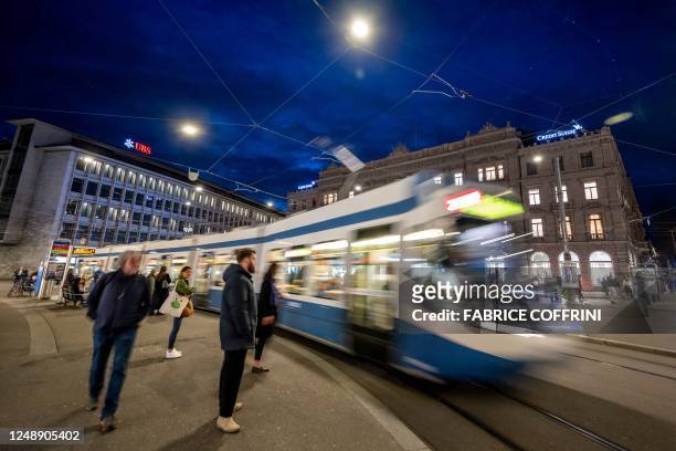 This photograph taken in Zurich on March 20 shows the headquarters of the Credit Suisse bank next to an offices of Swiss giant bank UBS. - UBS's...