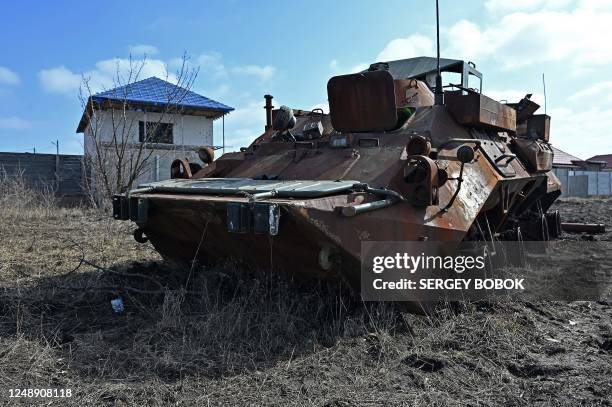 This photograph taken on March 20 shows a destroyed Russian armoured personnel carrier in the Tsirkuny village, Kharkiv region, amid the Russian...
