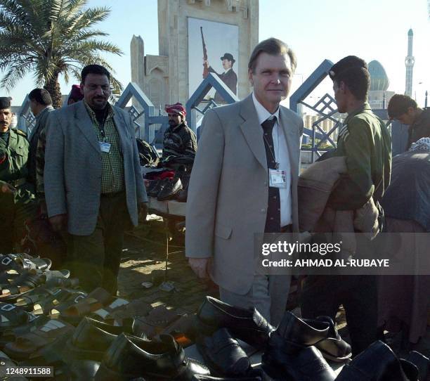 World Food Program Chief of Iraq Dane Torben Due visits 16 January 2003 the al-Alawi souk in Baghdad followed by his Iraqi driver and bodyguard. AFP...