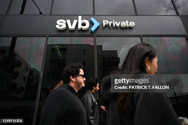The SVB Private logo is displayed outside of a Silicon Valley Bank branch in Santa Monica, California on March 20, 2023. - SVB, a key lender to...
