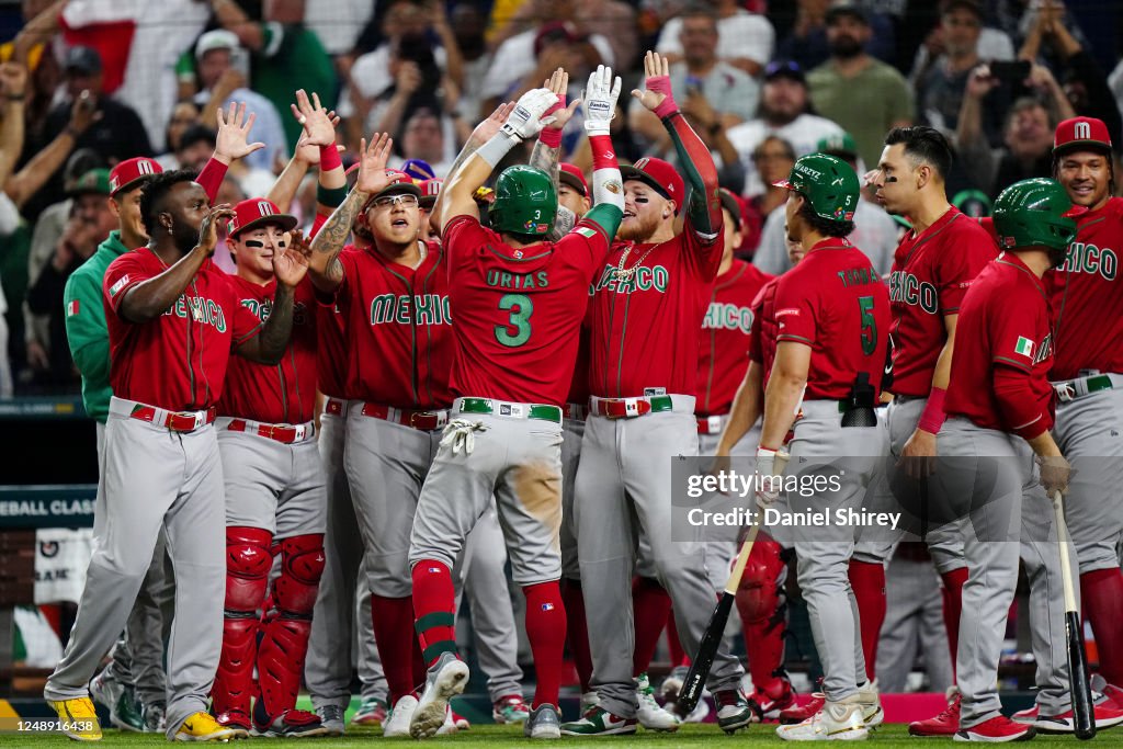 Mexico Baseball Roster Luis Urías of Team Mexico is greeted by teammates at home plate after ...