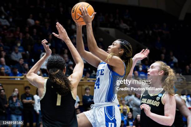 Reigan Richardson of the Duke Blue Devils drives the ball to the basket with Tayanna Jones of the Colorado Buffaloes attempts to block it during the...