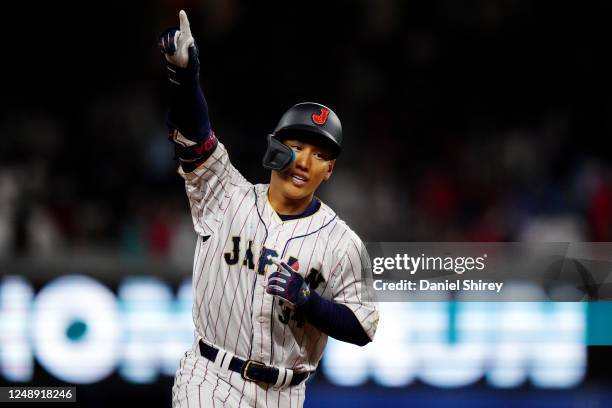 Masataka Yoshida of Team Japan rounds the bases after hitting a three-run home run in the eighth inning during the 2023 World Baseball Classic...