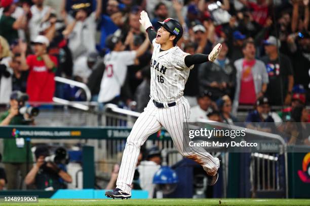 Shohei Ohtani of Team Japan rounds the bases to score on a three-run home run hit by Masataka Yoshida in the seventh inning during the 2023 World...