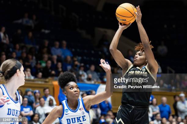 Jaylyn Sherrod of the Colorado Buffaloes shoots the ball with Shayeann Day-Wilson of the Duke Blue Devils attempting to block it during the second...