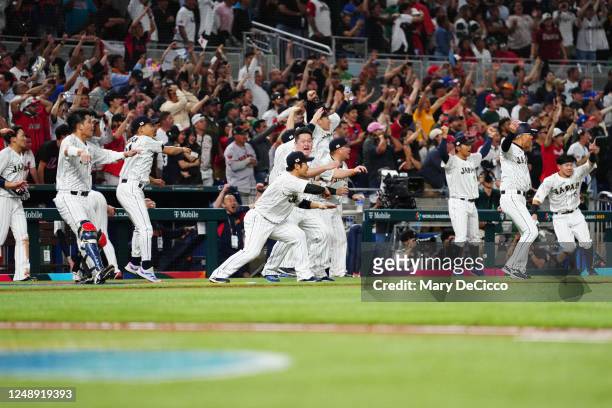 Members of Team Japan celebrate after Shohei Ohtani hit a double in the ninth inning during the 2023 World Baseball Classic Semifinal game between...