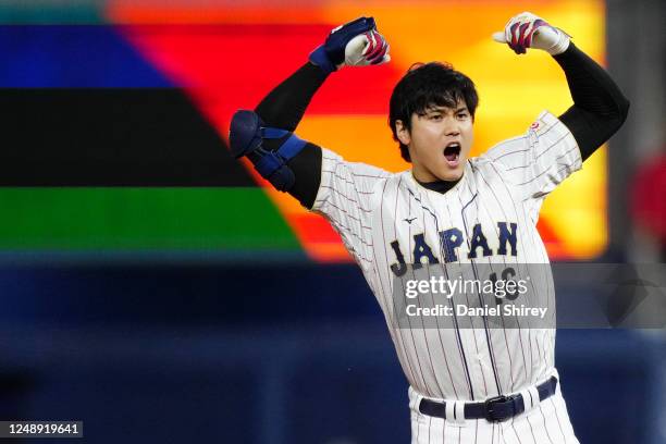 Shohei Ohtani of Team Japan reacts to hitting a double in the ninth inning during the 2023 World Baseball Classic Semifinal game between Team Mexico...