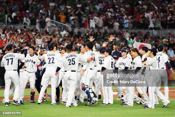 Members of Team Japan celebrate after Team Japans 6-5 victory in the 2023 World Baseball Classic Semifinal game against Team Mexico at loanDepot Park...