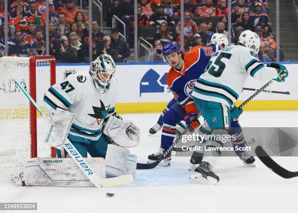 James Reimer of the San Jose Sharks makes a save with Kailer Yamamoto of the Edmonton Oilers in the area in the first period on March 20, 2023 at...