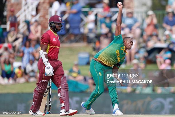 South Africa's Lungi Ngidi delivers a ball as West Indies' Kyle Mayers looks on during the third one-day international cricket match between South...