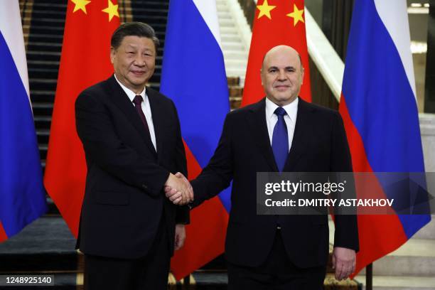 Russian Prime Minister Mikhail Mishustin meets with China's President Xi Jinping in Moscow on March 21, 2023.