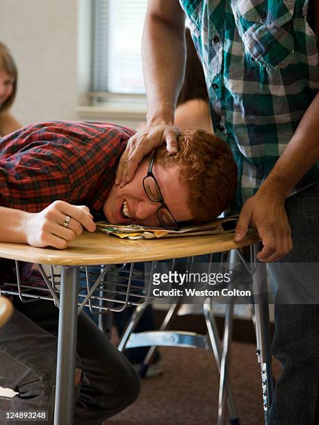 usa, utah, young man bullying teenage boy (16-17) in classroom - aggression school stock pictures, royalty-free photos & images