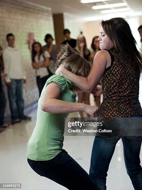 usa, utah, spanish fork, two girls (14-17) fighting in school corridor - aggression school stock pictures, royalty-free photos & images