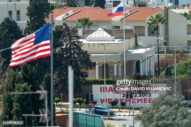 Large banner is displayed on the outer wall of the Russian embassy in Nicosia facing the US embassy with both countries' flags in the picture on...