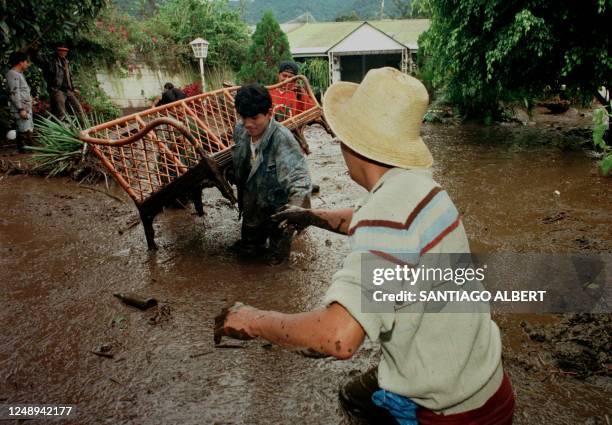 Residents of Antigua Guatemala, 45 Km southwest of Guatemala City, salvage a piece of furniture from a house flooded with mud and debris 04 November...