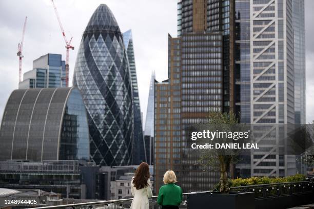 Britain's Catherine, Princess of Wales and NatWest chief executive officer Alison Rose, look out over buildings in the City of London including the...