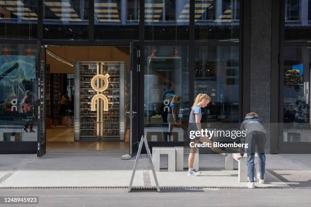 Runners stretch outside the On Labs flagship store, operated by On Holdings AG, in Zurich, Switzerland, on Tuesday, March 21, 2023. Swiss sneaker...
