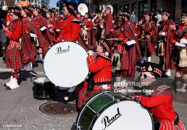 Boston, MA Members of the Ryan Russell Memorial Pipe Band take a break while their bagpipers perform at the 2023 St. Patrick's Day Parade.