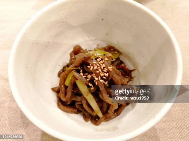 fried konjac with green onion, japanese traditional food - konjak stockfoto's en -beelden
