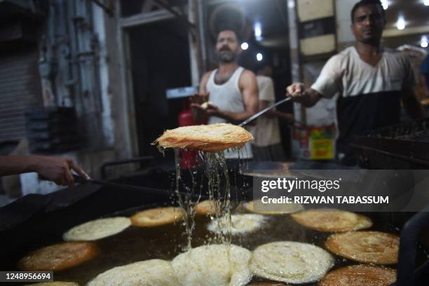 Workers fry vermicelli at a shop in Karachi on March 21 during preparations ahead of the Muslim holy fasting month of Ramadan.