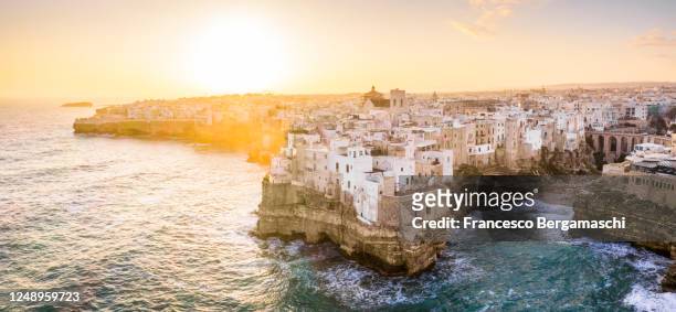 panoramic aerial view of the old town of polignano a mare at sunrise - bari italy stockfoto's en -beelden