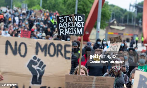 Black Lives Matter supporters carry placards as they march from Newport Civic Centre to Newport University on June 11, 2020 in Newport, Wales United...