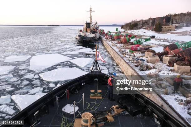 Crew members of the US Coast Guard 'Katmai Bay' Cutter ship prepare to moor at Lime Island following ice clearing operations in Sault Sainte Marie,...