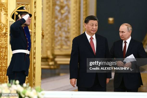 Russian President Vladimir Putin and China's President Xi Jinping enter a hall during a meeting at the Kremlin in Moscow on March 21, 2023.