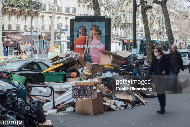 Uncollected bags of trash outside a restaurant during a sanitation workers strike in the Saint Michel district of Paris, France, on Tuesday, March...