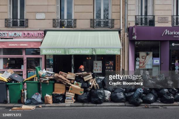 Uncollected garbage bins and bags of trash during a sanitation workers strike in Paris, France, on Tuesday, March 21, 2023. Due to a strike by...