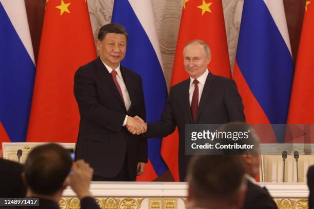 Chinese President Xi Jinping and Russian President Vladimir Putin shake hands during the signing ceremony at the Grand Kremlin Palace, on March 21,...