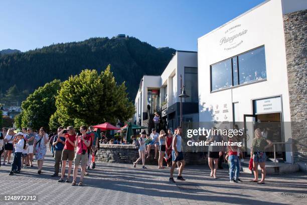 touristen auf der straße in queenstown auf south island - queenstown stock-fotos und bilder