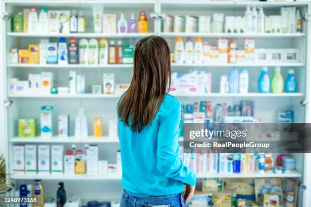 everything i need here. portrait of a beautiful female pharmacy customer - cosmetics shopping stock pictures, royalty-free photos & images