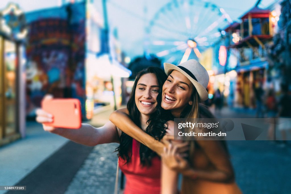 Friends on summer travel taking selfie together