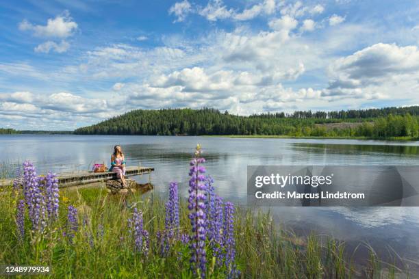 woman enjoying a summer day by the lake - jetty stock pictures, royalty-free photos & images