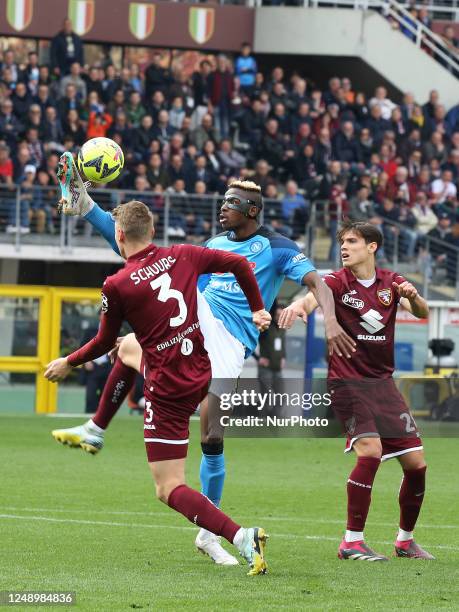 Victor Osimhen in action between Perr Schuurs and Samuele Ricci during the italian soccer Serie A match Torino FC vs SSC Napoli on March 19, 2023 at...