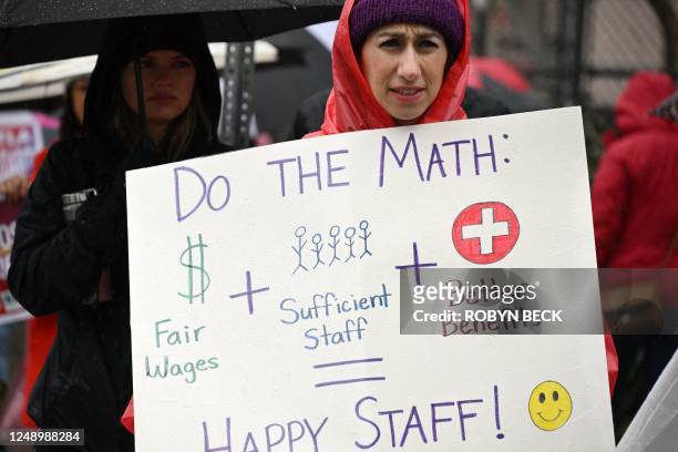 Los Angeles public school support workers, teachers, and supporters walk the picket line in front of an elementary school in Los Angeles, California,...