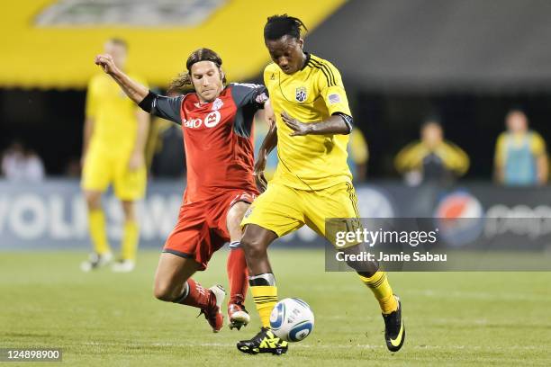 Andres Mendoza of the Columbus Crew and Torsten Frings of Toronto FC battle for control of the ball on September 10, 2011 at Crew Stadium in...