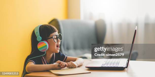 jeune fille asiatique mignonne étudiant avec l’ordinateur portatif à la maison pendant la pandémie - panoramic room photos et images de collection