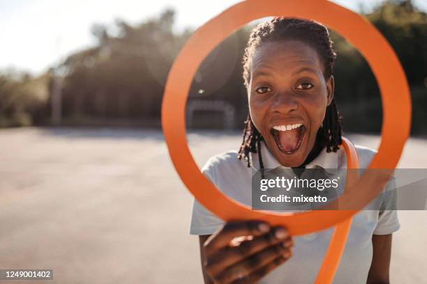 happy woman with hoola hoop on ring on playground - ring toss imagens e fotografias de stock