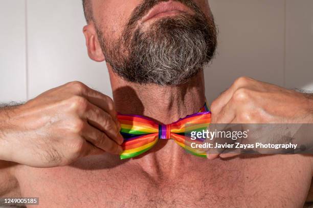 shirtless bearded man wearing a rainbow colored bow tie - neck tie stock pictures, royalty-free photos & images