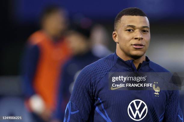 France's forward Kylian Mbappe leaves the pitch at the end of a training session in Clairefontaine-en-Yvelines on March 21, 2023 as part of the...