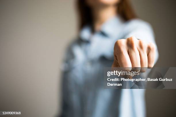 a woman clenching fist - riot icon stock pictures, royalty-free photos & images