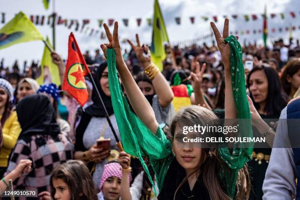 Syrian Kurds celebrate the Nowruz New Year festival in the countryside of al-Qahtaniyah in Syria's northeastern Hasakah province, close to the border...