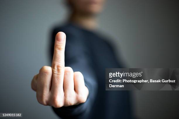 a woman's hand, making obscene gesture - doigt dhonneur stock pictures, royalty-free photos & images