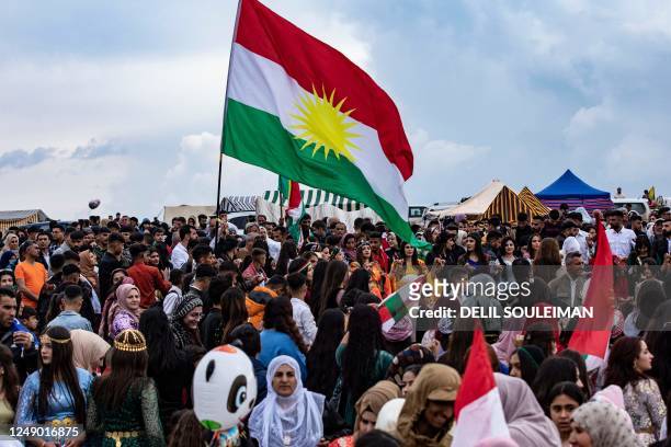 Syrian Kurds celebrate the Nowruz New Year festival in the countryside of al-Qahtaniyah in Syria's northeastern Hasakah province, close to the border...