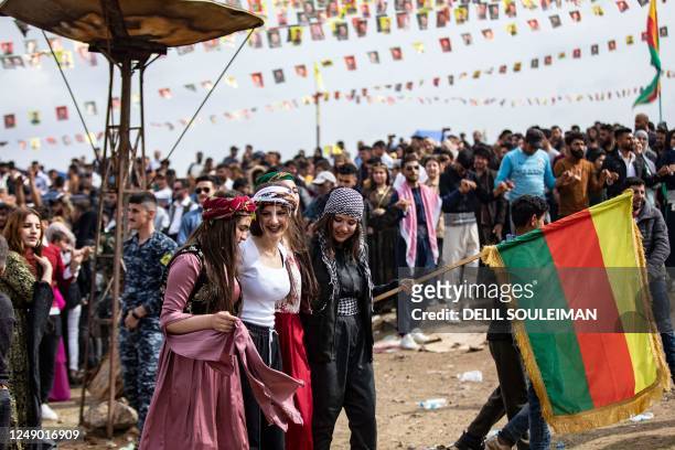 Syrian Kurds celebrate the Nowruz New Year festival in the countryside of al-Qahtaniyah in Syria's northeastern Hasakah province, close to the border...