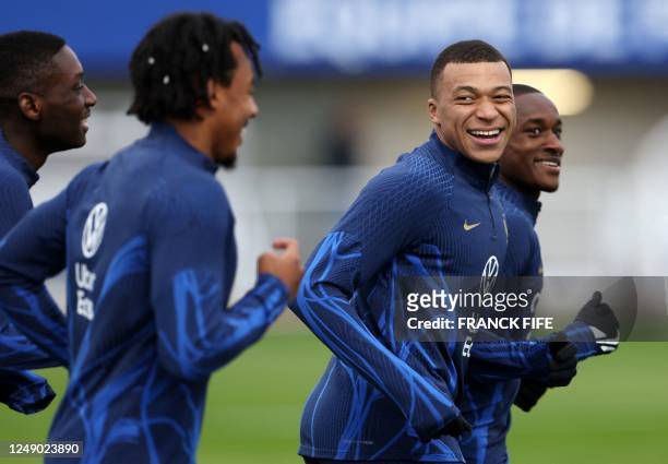 France's forward Kylian Mbappe takes part in a training session in Clairefontaine-en-Yvelines on March 21, 2023 as part of the team's preparation for...